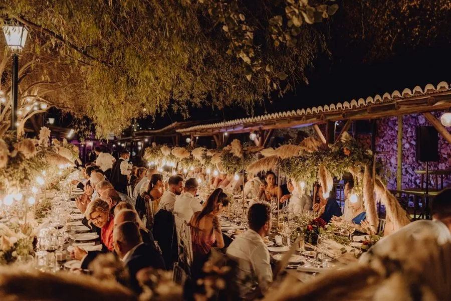 Evening wedding reception with pampas grass and warm lighting, a UK wedding planned by Swish Soirées